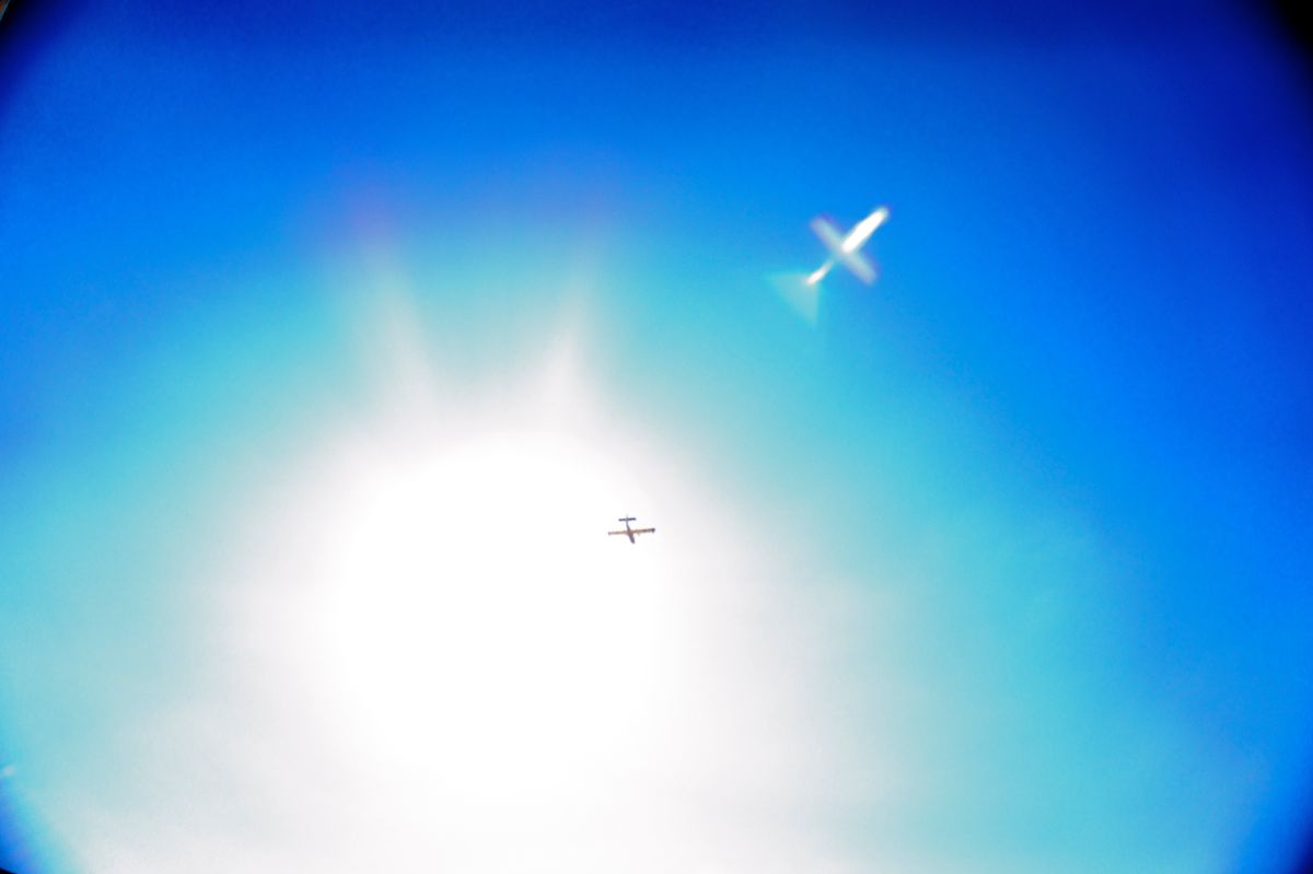 Plane reflection through noon sunlight